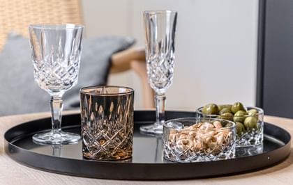 NACHTMANN Noblesse Series on a table top next to nuts and olives